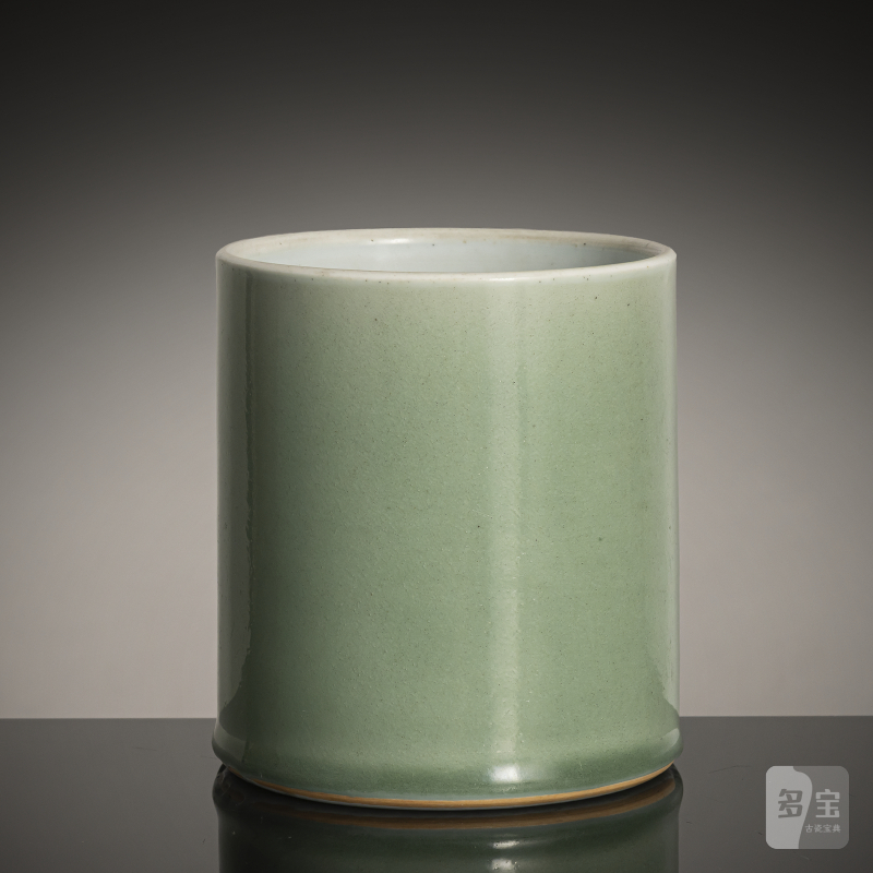 A cylindrical porcelain celadon brush pot